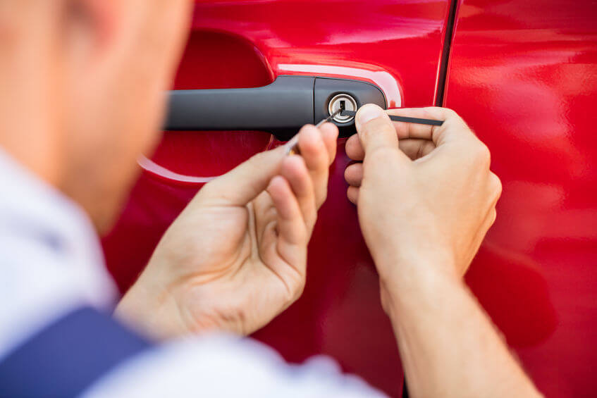 Locksmith unlocking a car